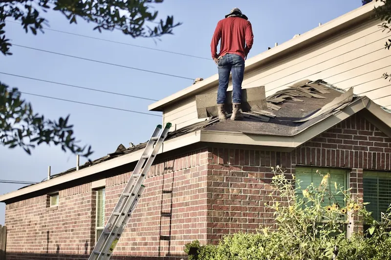 Professional roofer working on a residential roof in New Castle Junction